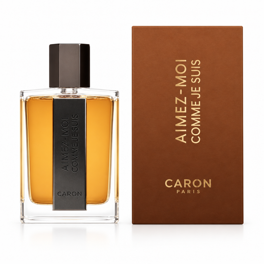Flacone ambrato e scatola marrone Caron Aimez-Moi Comme Je Suis su sfondo bianco